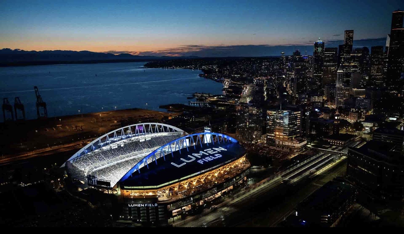 Lumen Field and the Seattle skyline illuminated at night